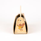 Wooden bell with a squirrel design on a white background