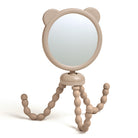 Beige handheld mirror with a flexible stand on a white background