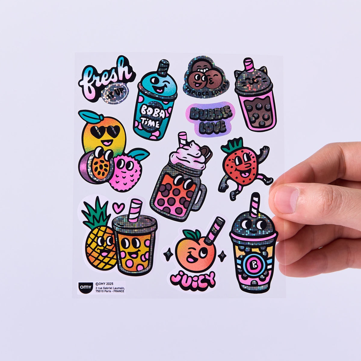 Sheet of colorful bubble tea-themed stickers held by a hand on a white background