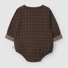 Brown checkered baby romper on a light gray background