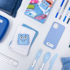 Collection of blue stationery items including notebooks, phone case, and cutlery on a white surface.