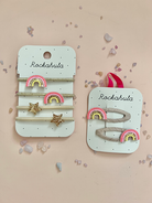 Set of hair accessories with rainbow and star designs on Rockahula branded cards.