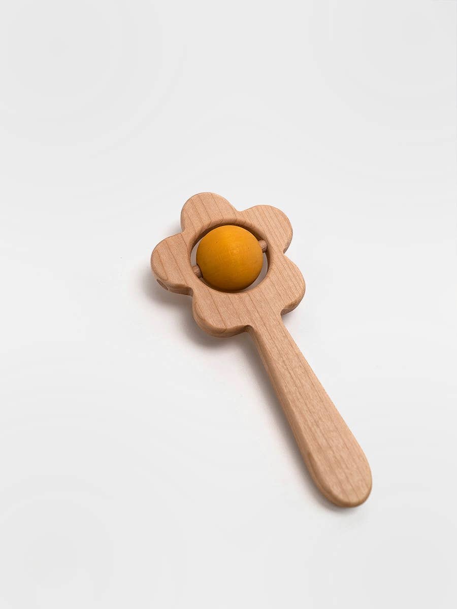 Wooden toy with a yellow ball on a white background