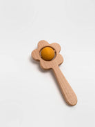 Wooden toy with a yellow ball on a white background