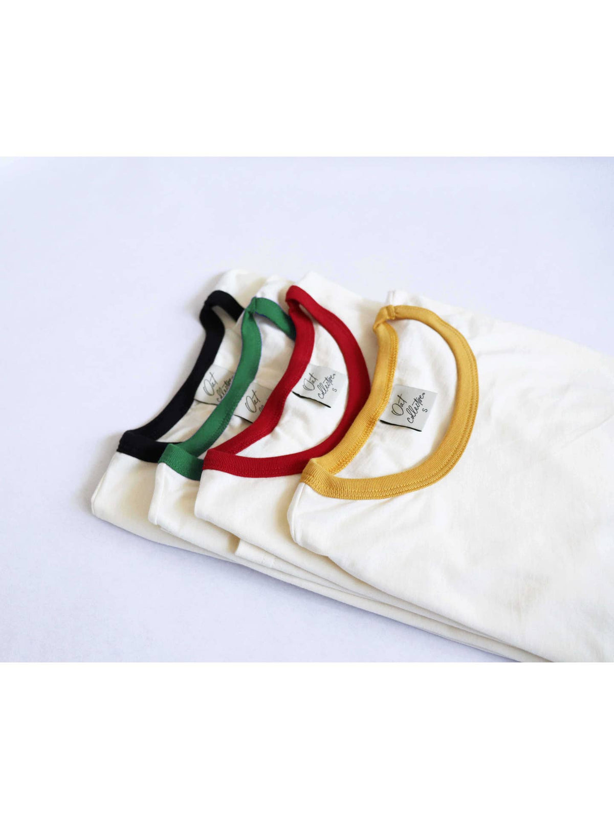Set of white t-shirts with colorful headbands on a light blue background