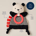 Panda-shaped toy with a textured ribbon and pink ring on a beige background