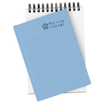 Light blue notebook with 'Melissa LeBlanc' branding on a white background