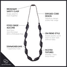 A black beaded necklace with features, elongated faceted beads and small spacer beads on a thin cord, shown against a plain white background.