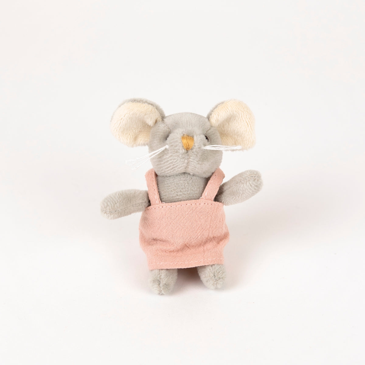 A small plush mouse toy with gray fur, cream-colored ears, and a pink apron, photographed against a plain white background.