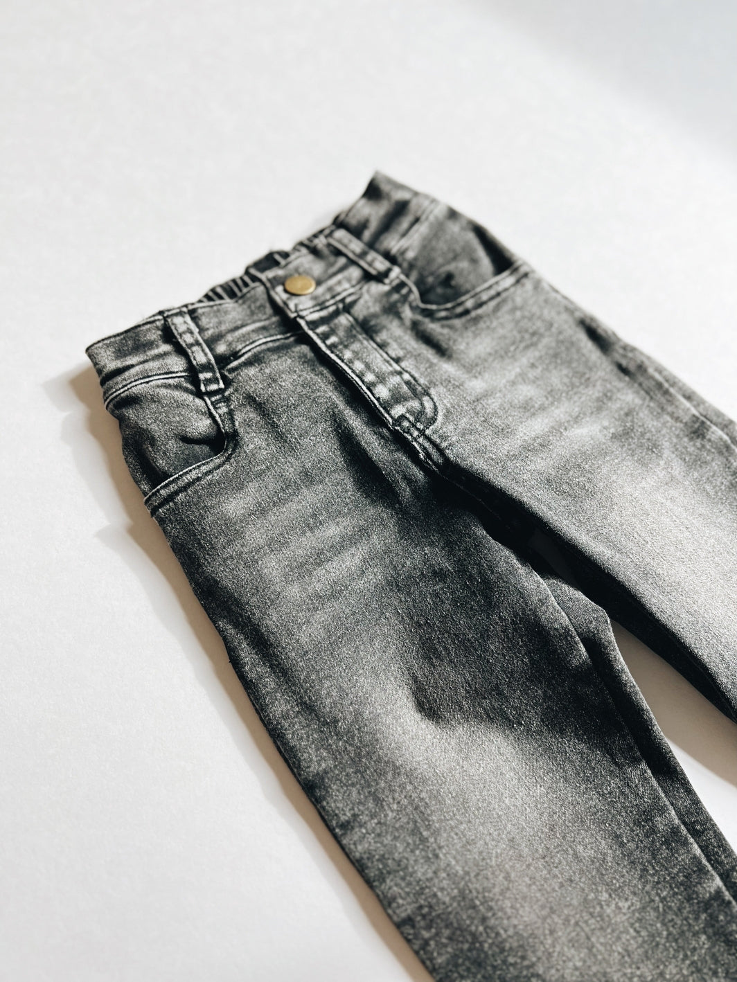 Pair of gray jeans on a white background