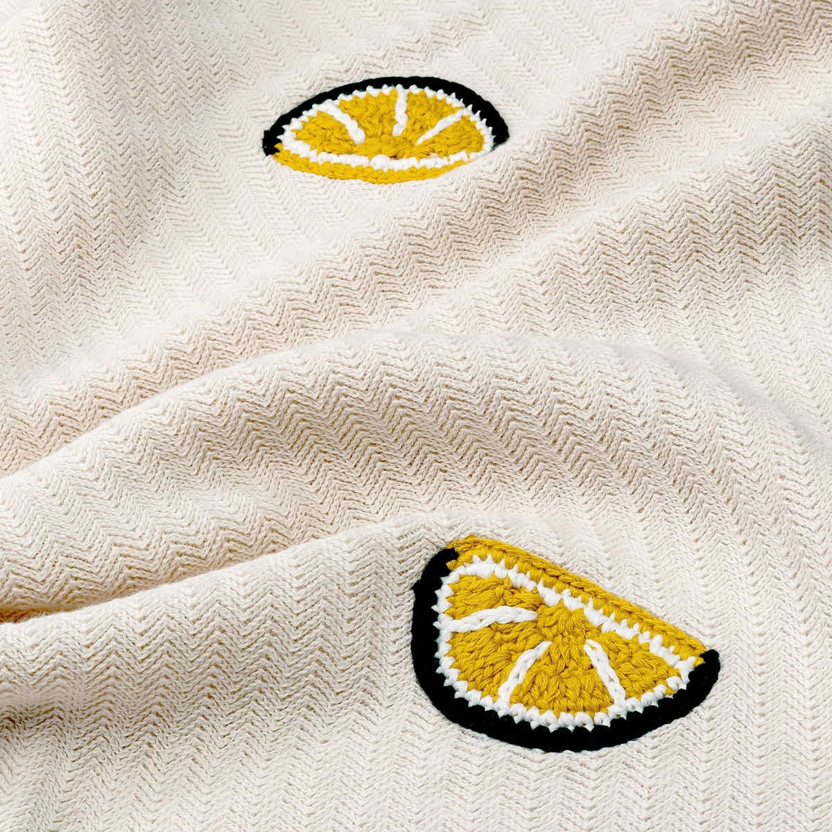 Beige fabric with embroidered yellow lemon slices