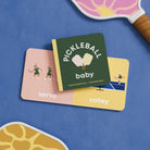 Children's book titled 'Pickleball Baby' on a blue background with paddle and ball graphics.
