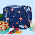 Space-themed lunch bag with snacks and drinks on a light blue background