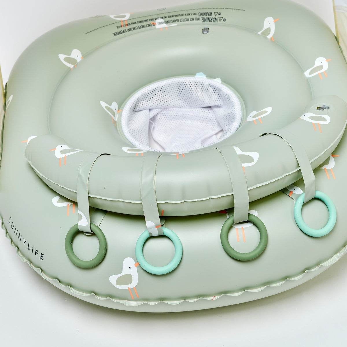 Green inflatable baby seat with seagull design on a white background