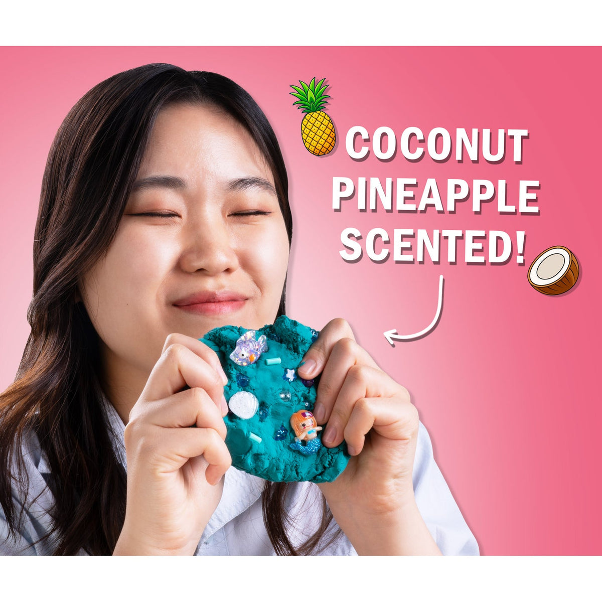 Person holding a coconut pineapple scented product with text on a pink background