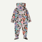 A hooded footed one-piece jumpsuit with a colorful floral and leaf pattern on a light pink base, shown from the back against a light gray background.