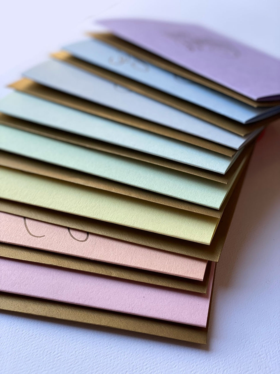 Set of colorful envelopes in pastel shades on a white background