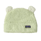 A light mint green Patagonia fleece beanie with two fluffy pom-poms on top and a black Patagonia logo patch on the front cuff, shown against a plain white background.