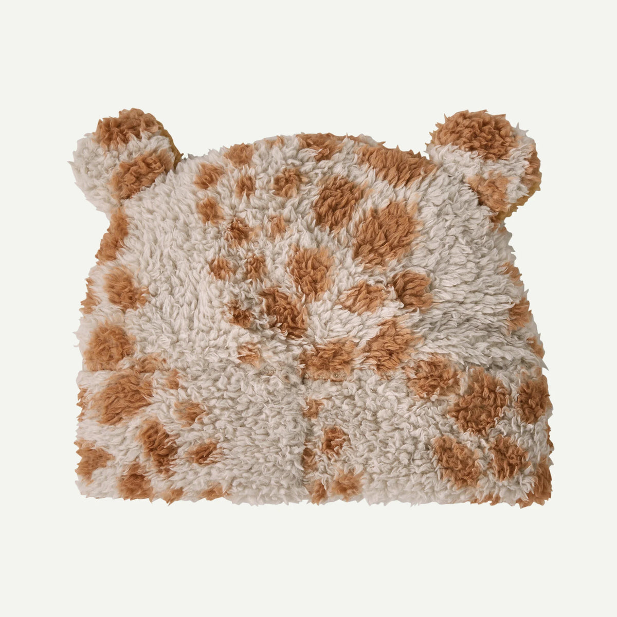 Fluffy pillow with brown and beige pattern on a white background