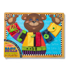 Educational toy board with bear character and various educational elements on a white background