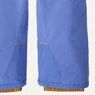 Close-up of the lower legs of blue pants showing a reflective silver stripe detail near the knees and a brown elasticated cuff at the bottom.