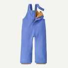 A pair of children's snow bib pants in a periwinkle blue color, featuring a tan interior lining and adjustable shoulder straps, shown against a light off-white background.