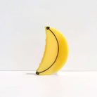 Yellow banana-shaped object on a white background