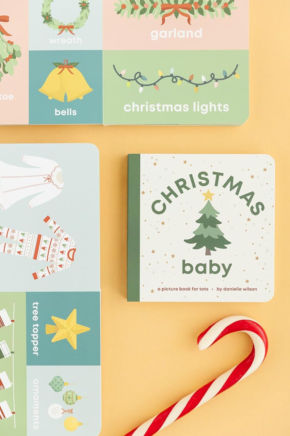 Children's book titled 'Christmas Baby' with Christmas-themed illustrations on a yellow background.