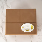 Brown box with a fish design on a marble surface