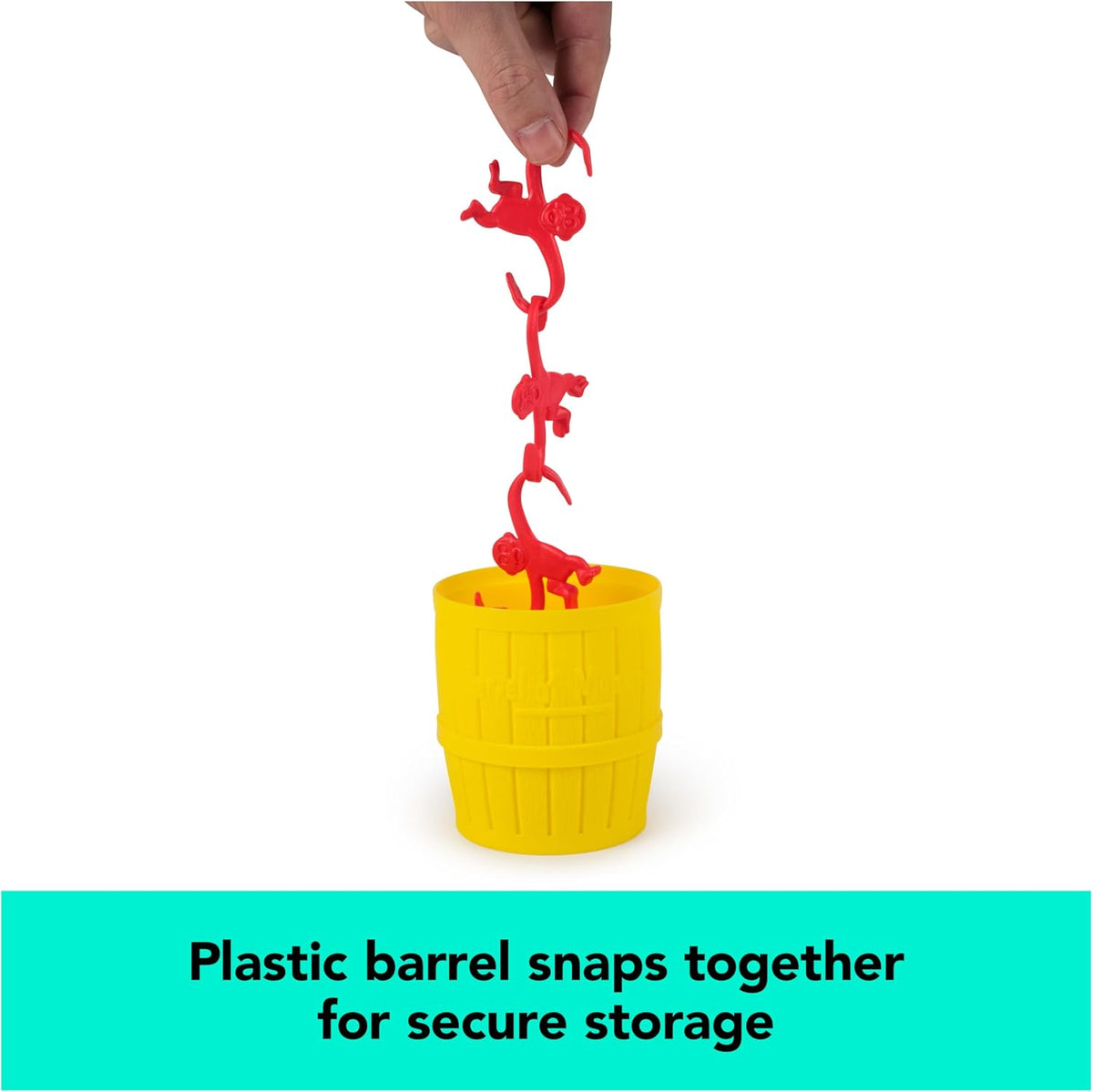 A person holding a vertical chain of red plastic monkeys suspended above a yellow plastic storage barrel for the Barrel of Monkeys Game by Continuum Games, accompanied by text reading "Plastic barrel snaps together for secure storage."