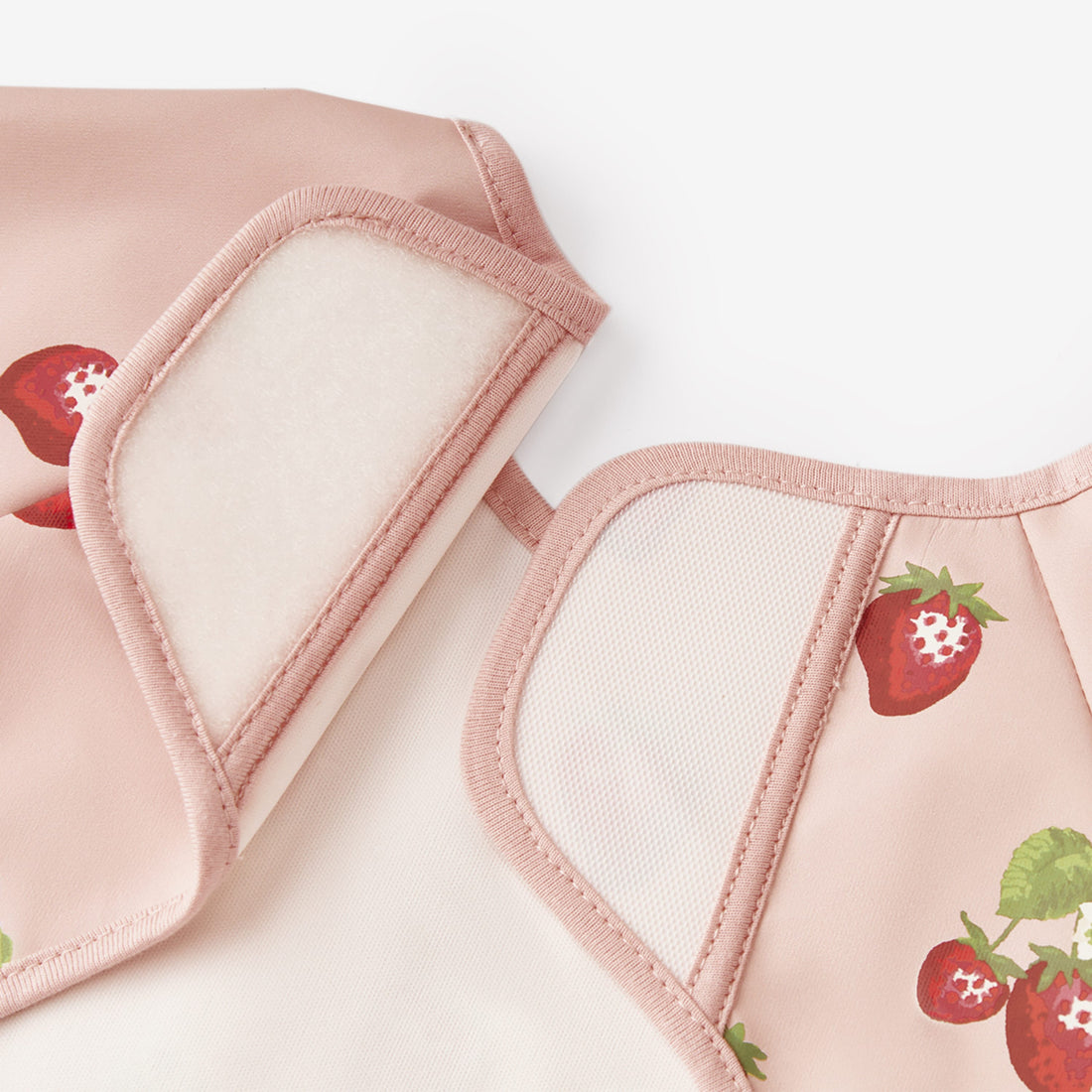 Pink baby bibs with strawberry design on a white background
