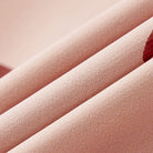 Close-up of pink textured fabric with a gradient background