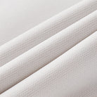 Close-up of textured beige fabric with a subtle pattern