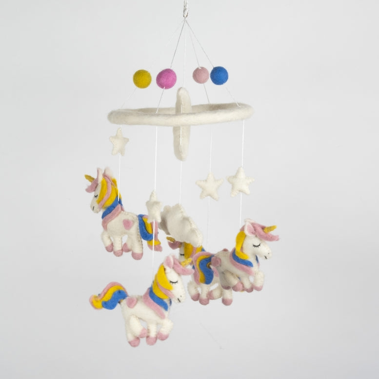 A white felt baby mobile featuring several pastel-colored unicorns with yellow and blue manes, a white cloud, and a ring with colorful felt balls at the top, shown against a plain white background.