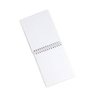 White notebook with a spiral binding on a white background