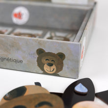 Close-up of a box with a bear design and a product inside, on a white background.
