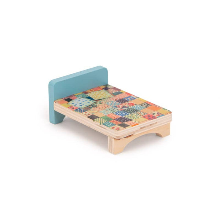 Small wooden bed with a colorful patchwork design on a white background