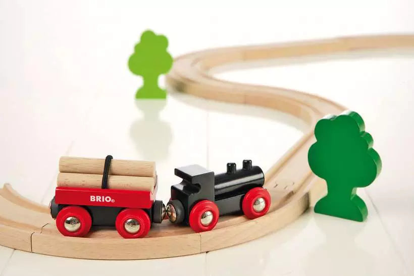 Wooden toy train set with trees on a white background