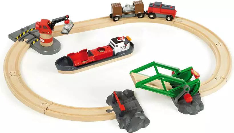 Toy train set with tracks, cars, and accessories on a white background