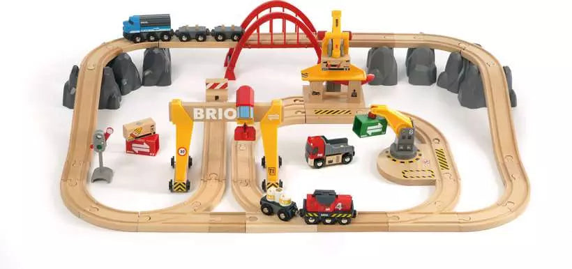 Wooden toy train set with tracks, bridges, and various train cars on a white background