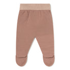 A pair of baby footed knit pants in a dusty rose pink color, featuring a ribbed elastic waistband, shown flat on a white background.