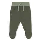 A pair of infant knit footed pants in olive green, featuring a ribbed waistband and matching drawstring.