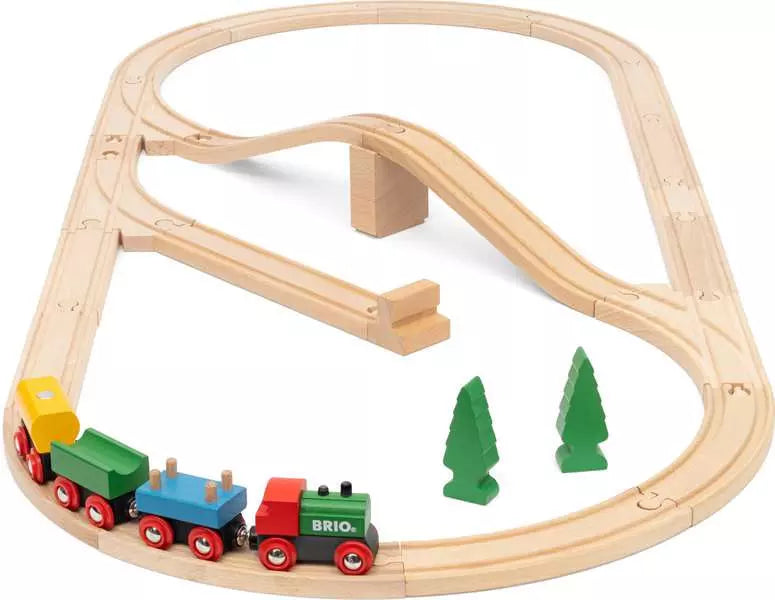 Wooden train set with tracks and trees on a white background