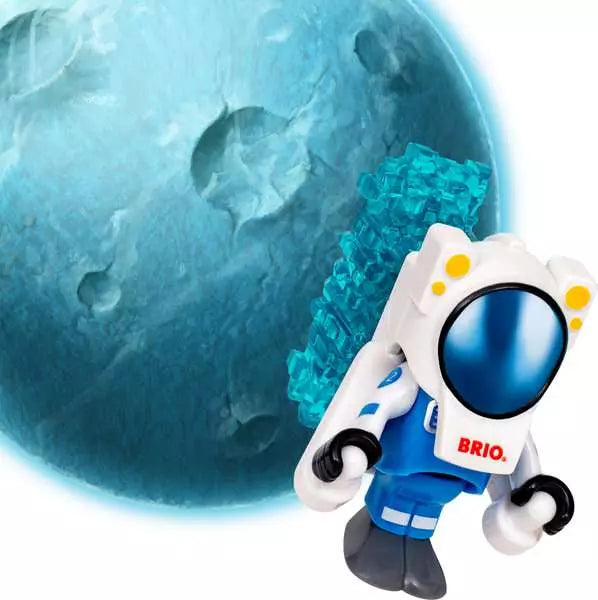 A Brio astronaut toy floating in front of a large blue planet, with the Brio brand name visible on the chest.