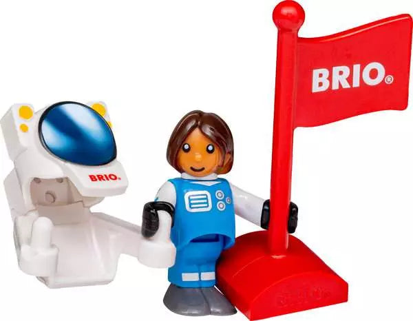 Brio toy set featuring a white astronaut figure with a blue visor, a blue-and-white astronaut minifigure, and a red flag on a red base, all on a white background.