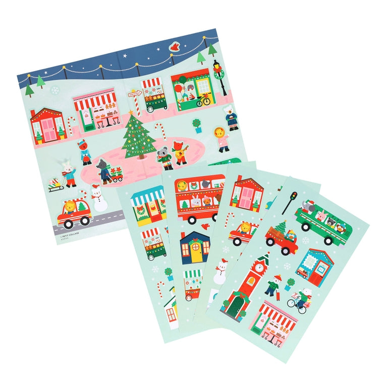 A product photo of the Christmas Town Mini Sticker Set by Petit Collage featuring multiple green sticker sheets fanned out with festive illustrations of holiday buildings, vehicles, and characters.