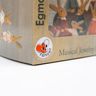 Close-up of the packaging for the Egmont Musical Jewelry set, showing a beige cardboard box with bunny illustrations and a circular Egmont logo sticker.