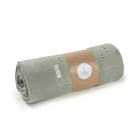 Roll of green fabric with a brown label on a white background
