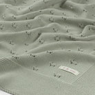 Textured green fabric with a label on a white background