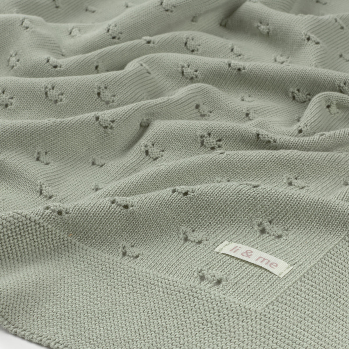 Textured green fabric with a label on a white background